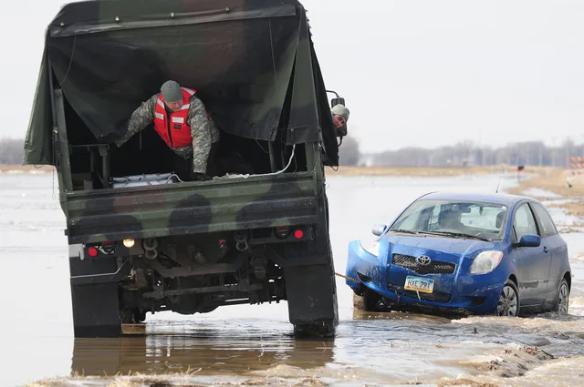 Spc. Jeremy Kasperson sits in the rear of a North Dakota National Guard truck as he gives directions for backing out of a washed out road March 25 in rural Cass County. The truck is towing a stranded automobile from the washed out roadway. Cass County Tactical Operations Center liaison officer Capt. Which markets suit a towing company for a small operation