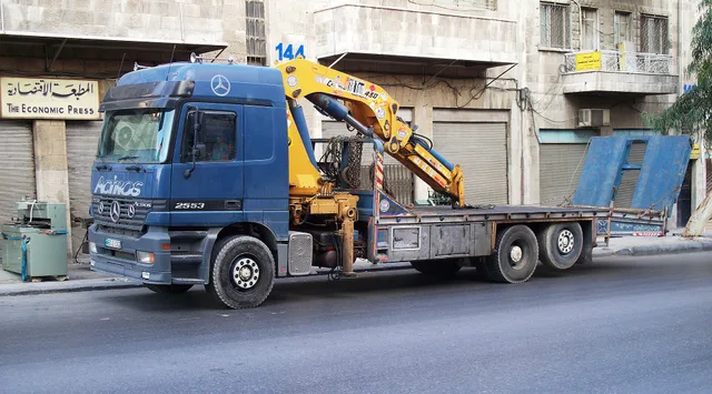 A Mercedes-Benz Actros tow truck in Amman, Jordan. Flatbed vs wheel-lift for electric vehicle towing in California