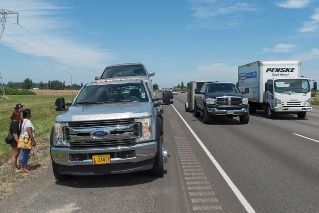 Sometimes, things happens. And driving down the highway with your family becomes more of an adventure than you anticipated. A tow truck assists a family on the shoulder of the highway. Waaay off behind them, an ODOT incident responder adds a layer of safety, letting traffic know there's an incident. How FMCSA rules shape American tow truck operations
