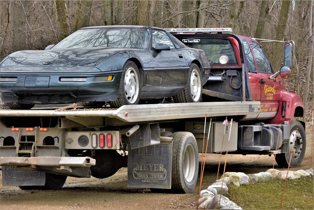 corvette, broken, needs repair, on truck, vehicle, transport, automobile, sports car, hauled, nature, remote, woods, forest, boondocks, large, wide, tires, powerful, fast car, going to repair shop, truck hauler, flatbed, flatbed hauler, brown car, brown shop, brown truck, brown power. How to start a one truck towing company in the United States: permits, insurance and the first calls