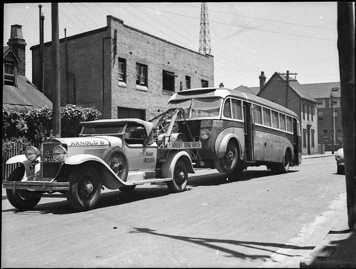 A Bedford Motor bus being towed to Queensland by Arnold's Towing Services using a 1929 Cadillac tow truck, 1 December 1938, by Sam Hood, from nitrate negative, State Library of New South Wales, Home and Away - 19462. What IRS Form 1099-NEC means for American tow truck owner-operators
