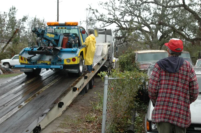 [Hurricane Katrina] Pass Christian, Miss., January 17, 2006 -- Wrecker driver Johnny Hogan looks on as a used wrecker donated by the California Tow Truck Driver's Association is delivered. Mr. Hogan lost his wrecker due to Hurricane Katrina. Mark Wolfe/FEMA. Should a towing company buy new or used equipment for owner-operators